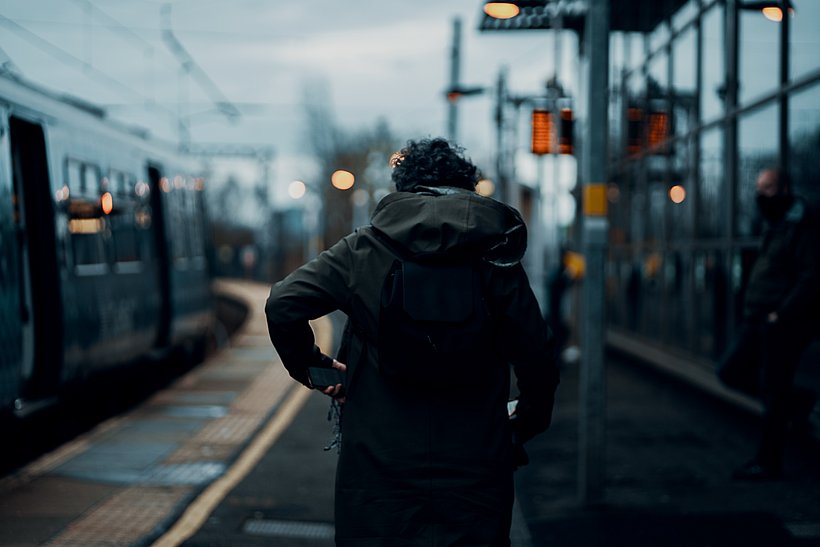 Man walking towards a train